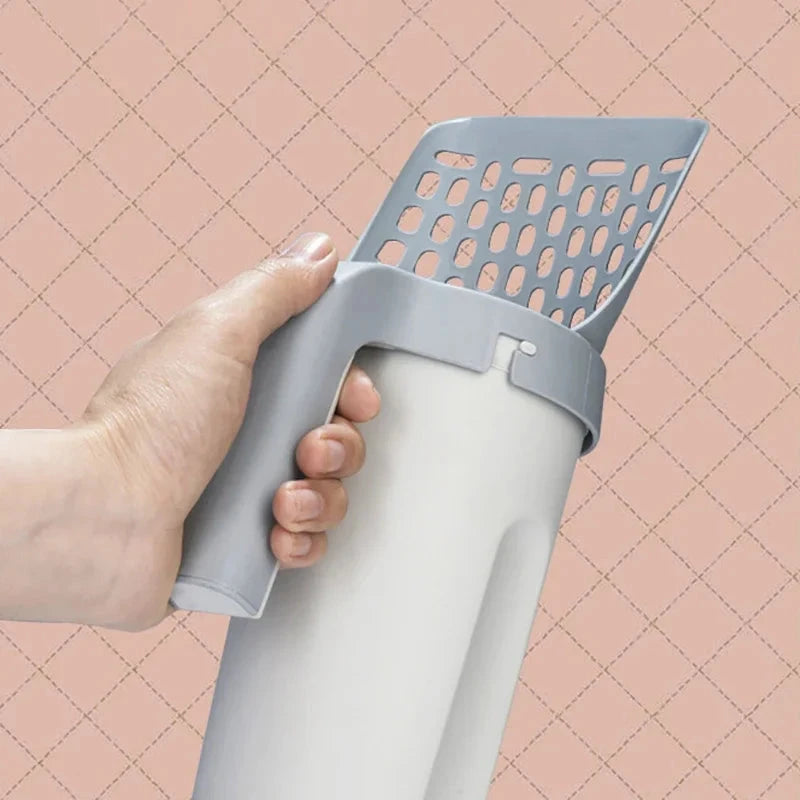 Hand holding a gray and white plastic scoop against a pink grid background