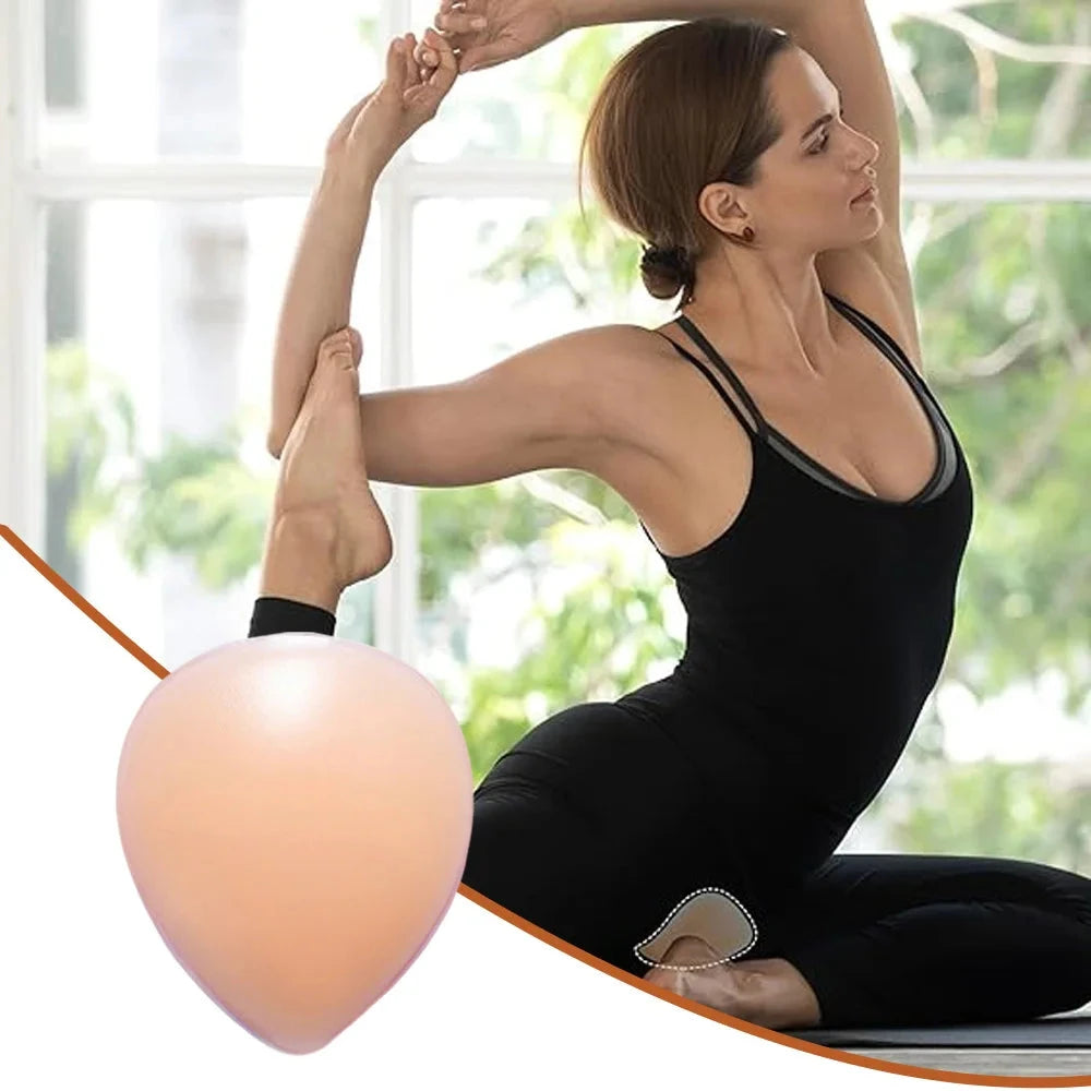 A woman in a black athletic tank top and leggings performs a yoga pose indoors near a bright window, with a peach-colored silicone knee pad visible near her knee.
