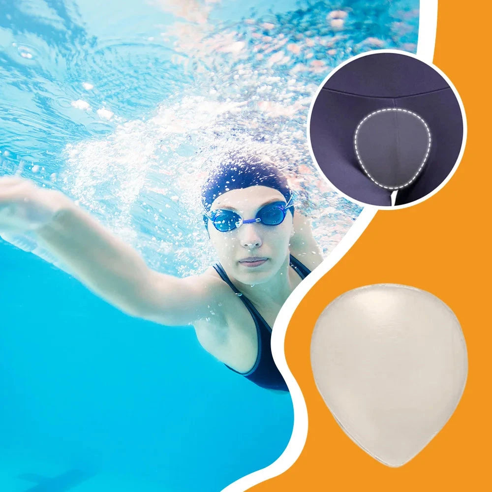 Person swimming underwater with a close-up of a swim cap and goggles on an orange and blue background.