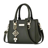 Black handbag with decorative charm on a white background