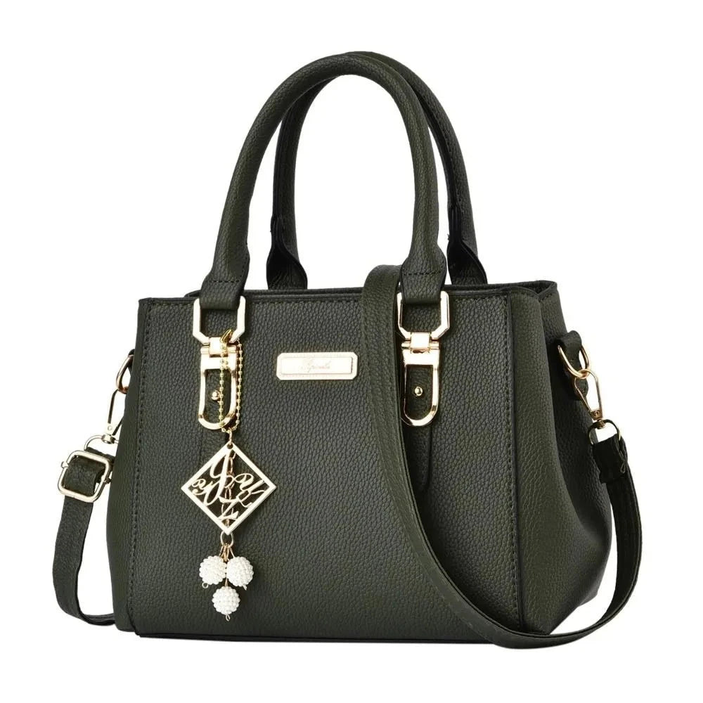 Black handbag with decorative charm on a white background
