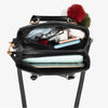 Black handbag with colorful pom-poms on a white background