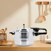 Pressure cooker on a kitchen counter with utensils in the background