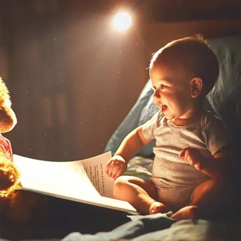 Baby reading a book with a teddy bear in a cozy setting