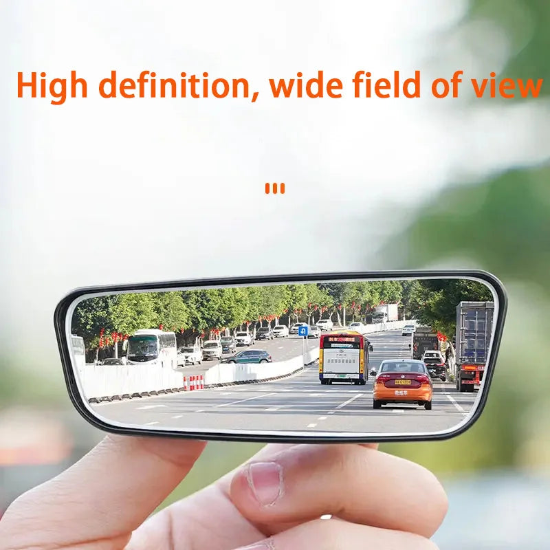 Car rearview mirror with wide field of view and high definition, held by a hand.