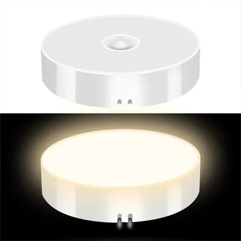 Round white light fixture with on/off switch on a white background