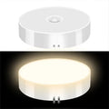 Round white light fixture with on/off switch on a white background
