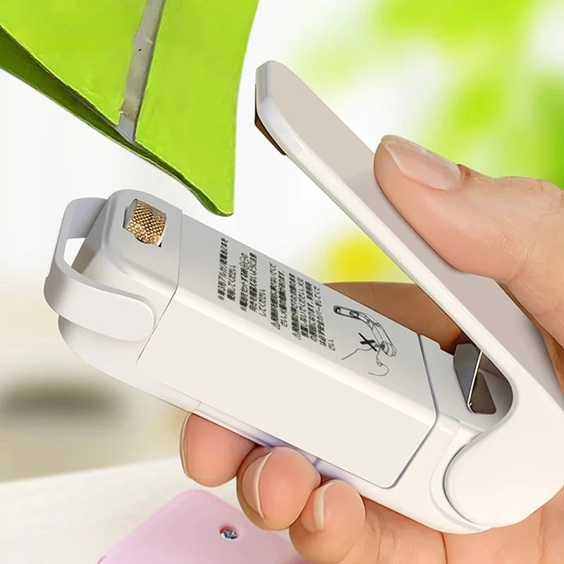 Person holding a white electronic device with a blurred green background