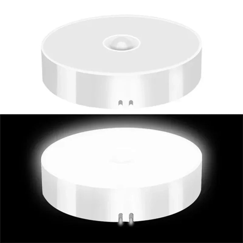 Round white device with a light feature on a black background