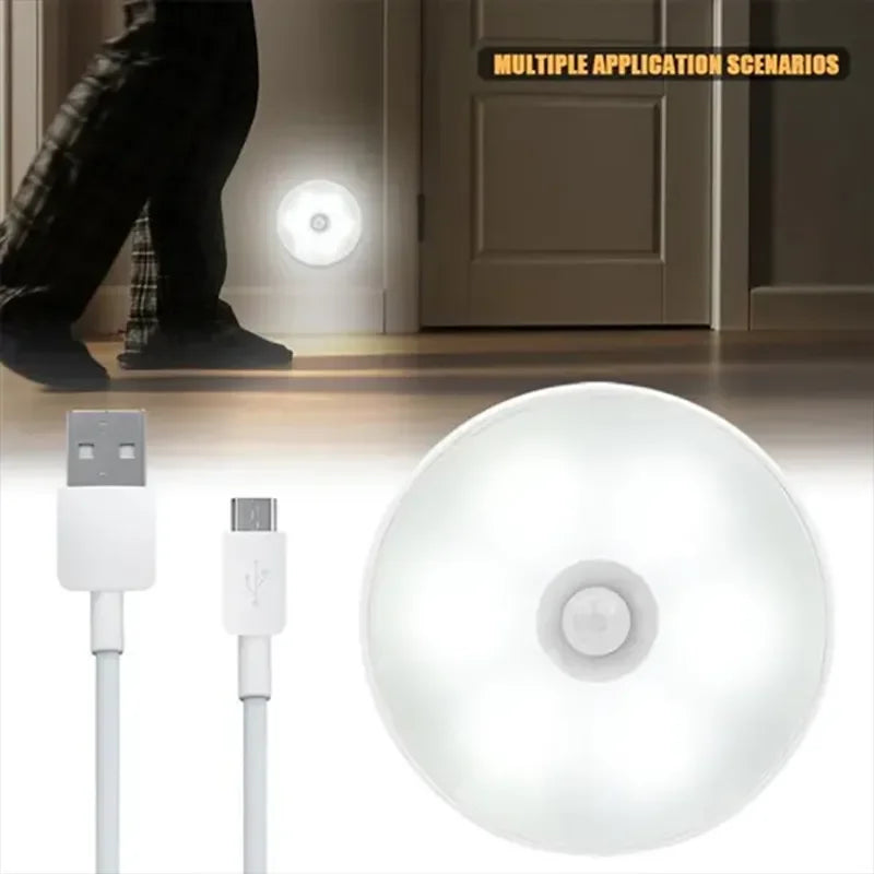 White motion sensor light with USB cable on a wooden floor background