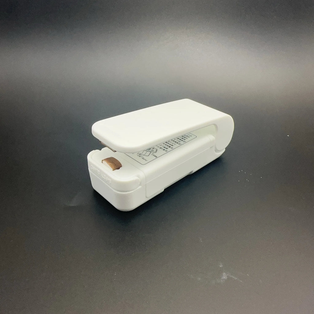 White stapler on a dark gray surface