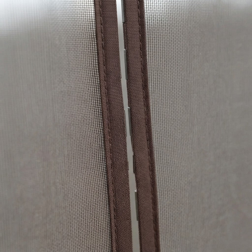 Close-up of a brown zipper track and mesh door panel on a light gray fabric closet door.