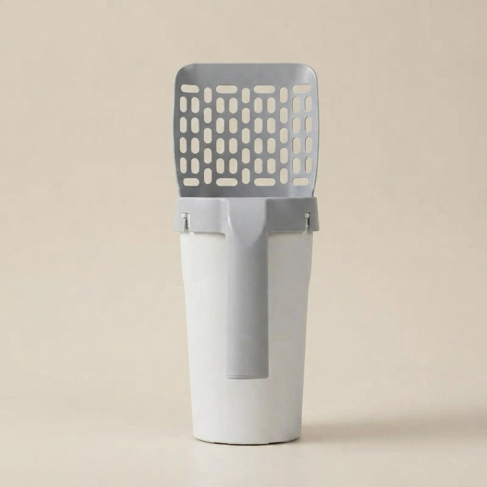 A modern gray and white plastic litter box scoop with a slotted top, shown on a solid beige background.