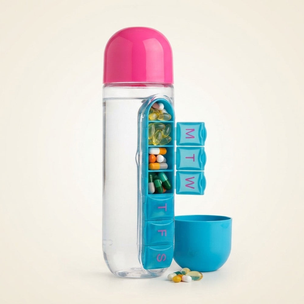 A clear pill bottle with a bright pink cap and a blue weekly organizer panel showing compartments for each day of the week. Several colorful capsules are visible inside the bottle and a few spill out in front, with a matching blue cup beside it on a light beige background.